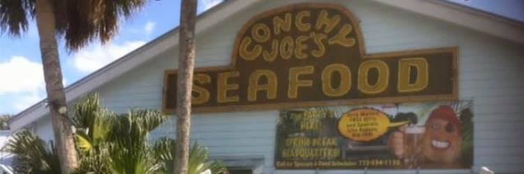 Conchy Joe's neon sign on clapboard exterior