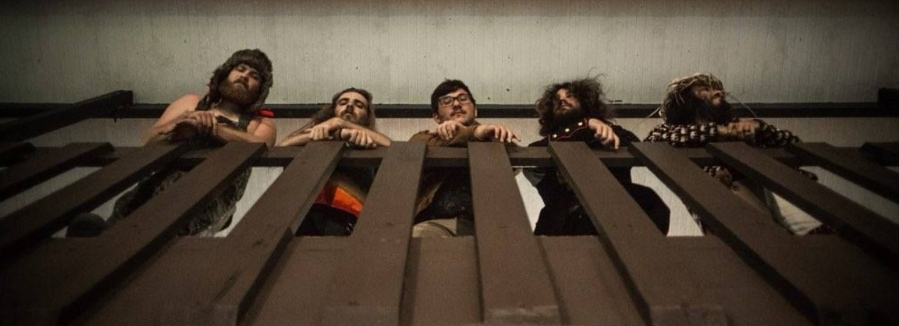 Humble Fish band members on a balcony railing